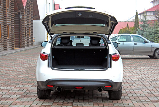Japan white SUV open trunk. Open empty trunk in the modern SUV. Car boot space shot. Modern SUV open trunk. Ready for luggage loading.
