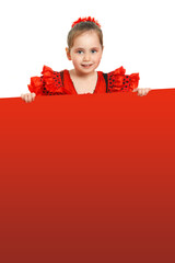 A little girl in a red Spanish dress with a poster in her hands. Place for text