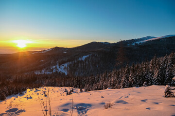 Sunrise over snowy mountain landscape of Kor Alps, Carinthia Styria, Austria. Snow covered alpine...