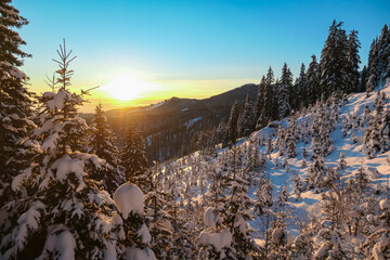Sunrise over snowy mountain landscape of Kor Alps, Carinthia Styria, Austria. Snow covered alpine...