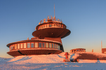 Winter, sunrise time,  disc shaped meteorological observatory in snezka, mountain on the border...
