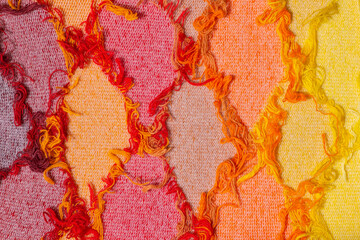 Colorful threads. Argyle pattern. Warm colors. Red shades background