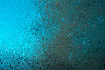 Frosty window with a natural pattern created by Mother Nature. Cracked background in blue green...