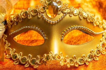 Gold carnival mask ornamented with silver beads, sequins, and gemstone