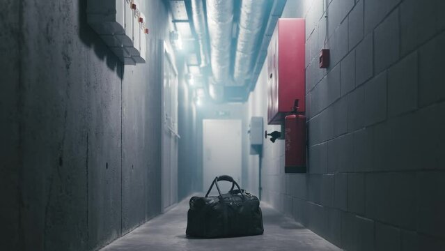 Forgotten black bag. Bomb in the bag. Abandoned mysterious bag.