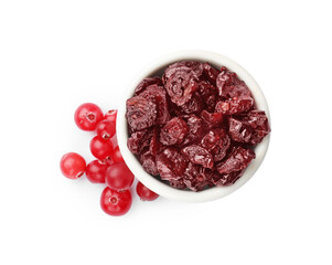 Dried cranberries in bowl and fresh berries on white background, top view