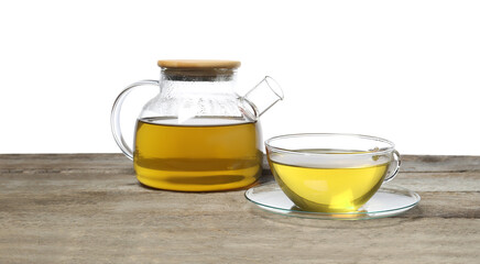Obraz premium Refreshing green tea in cup and teapot on wooden table against white background