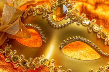 The carnival decoration concept made from golden theatre mask on a fiery background