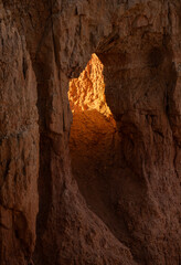 Bright Light Fills the Tunnel Through A Hoodoo In Bryce