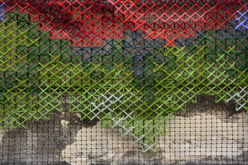 Handmade cross-stitch.Embroidered red rose .