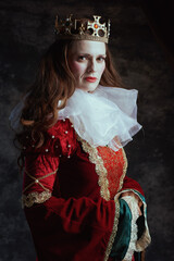 medieval queen in red dress with white collar and crown