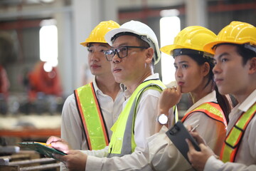 worker or engineer working in factory with safety uniform , safety hat and safety glasses , image is safety concept or happy workplace - obrazy, fototapety, plakaty