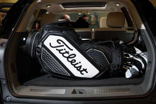 Titleist, golf bag and equipment in trunk of a car