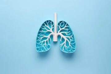 Blue paper lung cutout with white branches, a creative take on pulmonary health. Blue and White Lung Artwork