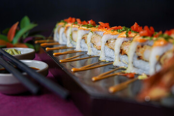 Ebi Tempura Roll served on a black wooden plate, avocado, cucumber, lump crab meat, sushi menu, social media post, food photography, fine dining, Japanese food, purple background