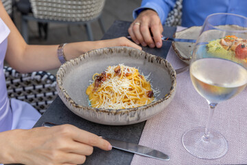 Pasta carbonara served on a plate at a restaurant table