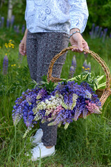 A girl carries a basket of flowers