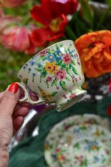 A beautiful antique cup in the girl's hand