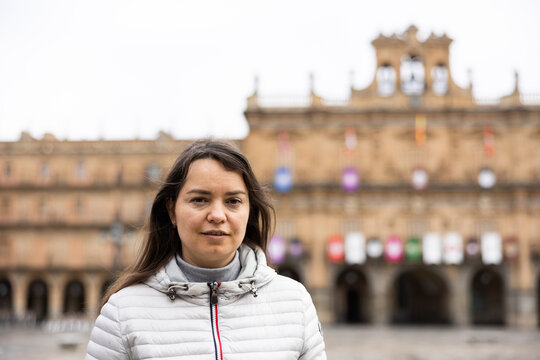 Portrait of a young female tourist standing on Plaza Mayor square in Salamanca, Spain
