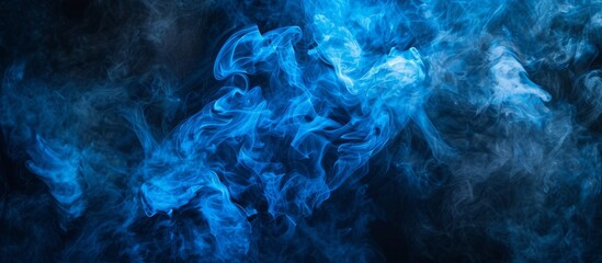 Ethereal blue smoke swirls on dark black background, abstract and mysterious atmosphere