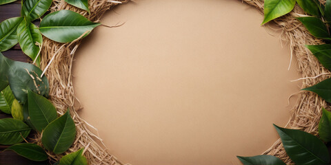 Still life of a straw wreath with green leaves on a brown wooden background. - obrazy, fototapety, plakaty