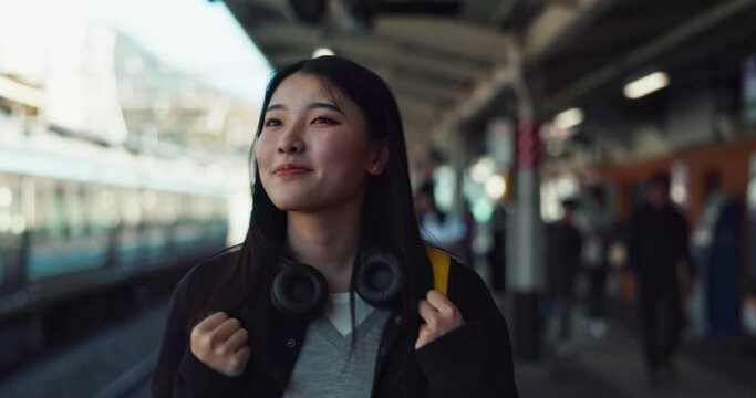 Asian, woman at train station for travel, commute or holiday with smile on face and freedom outdoor. Railway, walking on platform and transportation, journey for adventure in China with happiness