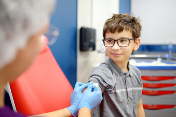 A boy is being vaccinated. A child is given a vaccine during an epidemic or outbreak of a disease.