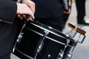 Close-up of a brass band drum in a processional parade.