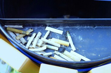 Smoked cigarettes in a garbage ashtray