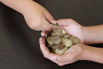 Turkish coins in the child's palm. accumulation and savings.