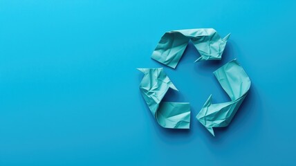 Crumpled paper forming recycling symbol on blue