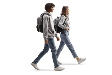 Full length profile shot of an african american male student and a caucasian female student walking