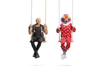 Punk and a clown swinging on swings