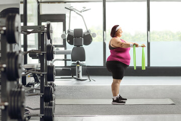 Woman at a gym exercising with a resistance band