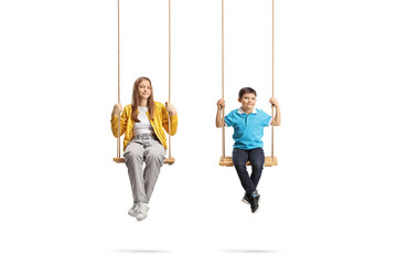 Boy and girl sitting on swings and looking at camera