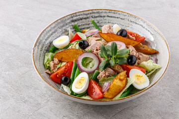 salad with tuna, quail egg and olives studio food photo 1