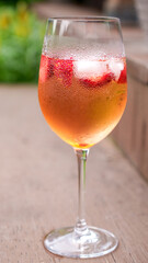 Fresh summer cocktail with strawberry and ice cubes. Glass of strawberry soda drink on dark background. Fresh strawberry cocktail.