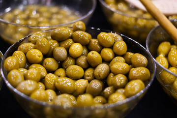 Green olives in a bowl. Mediterranean food. 