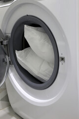 White pillow in washing machine.