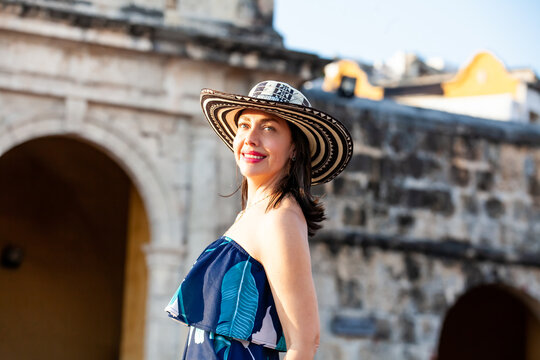 Beautiful woman wearing the traditional Colombian hat called Sombrero Vueltiao at the Peace Square on the historical streets of the Cartagena de Indias walled city