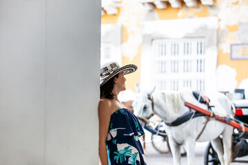 Beautiful woman wearing the traditional Colombian hat called Sombrero Vueltiao at the Customs...