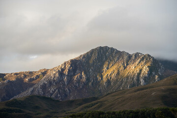 clouds over mountains over the water in a national park and beautiful rock mountain above the ocean in a national park