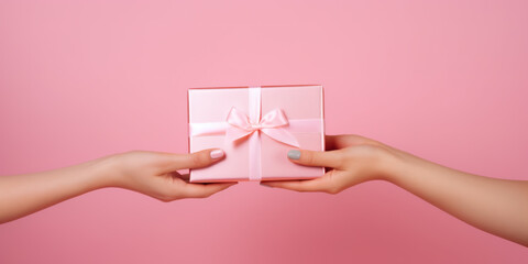 Woman gives a gift to another girl on a pink background