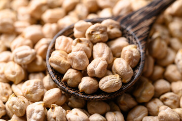Organic dried chickpea in wooden spoon, Healthy food ingredient
