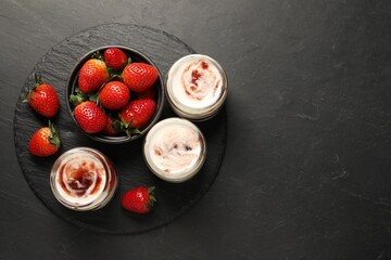 Tasty yoghurt with jam and strawberries on black table, top view. Space for text
