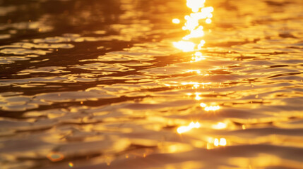 Obraz premium The tranquil lake is bathed in shades of gold and amber as the sun sets creating a sense of calm and serenity.
