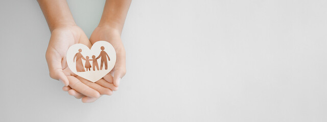 hands holding paper family cutout, family home, adoption foster care, homeless support , mental...