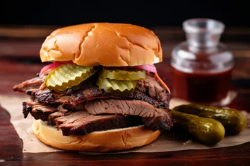 Foto op Canvas Smoked barbeque beef brisket sandwich with pickles and bbq sauce © fahrwasser