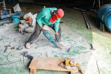 Worker use jack hammer drill concrete hold for install foundation.