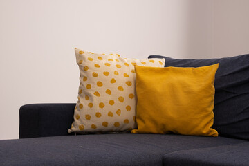  Yellow and white polka dot pillows lie on the sofa. Home comfort